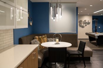 A dining area with a table and chairs 